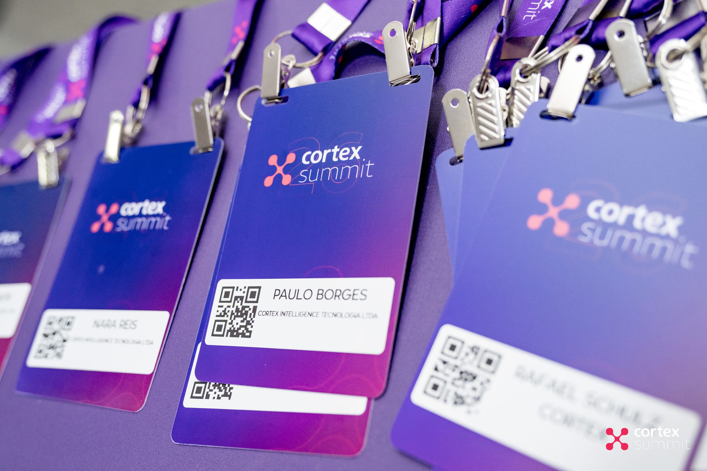 Close-up of Cortex Summit attendee badges with gradient purple cards and QR codes