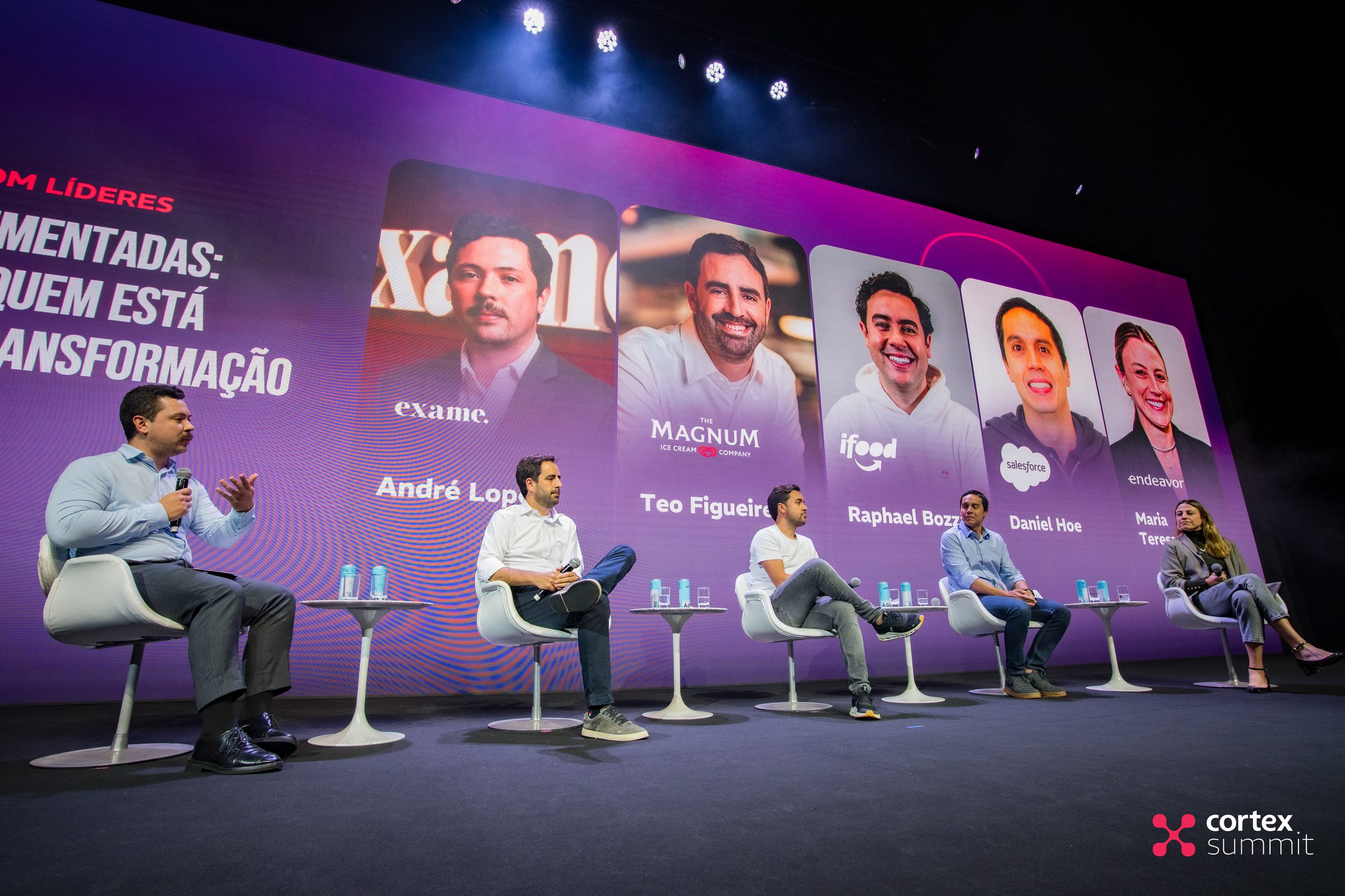 Panel of five speakers seated on stage in front of the lineup LED wall