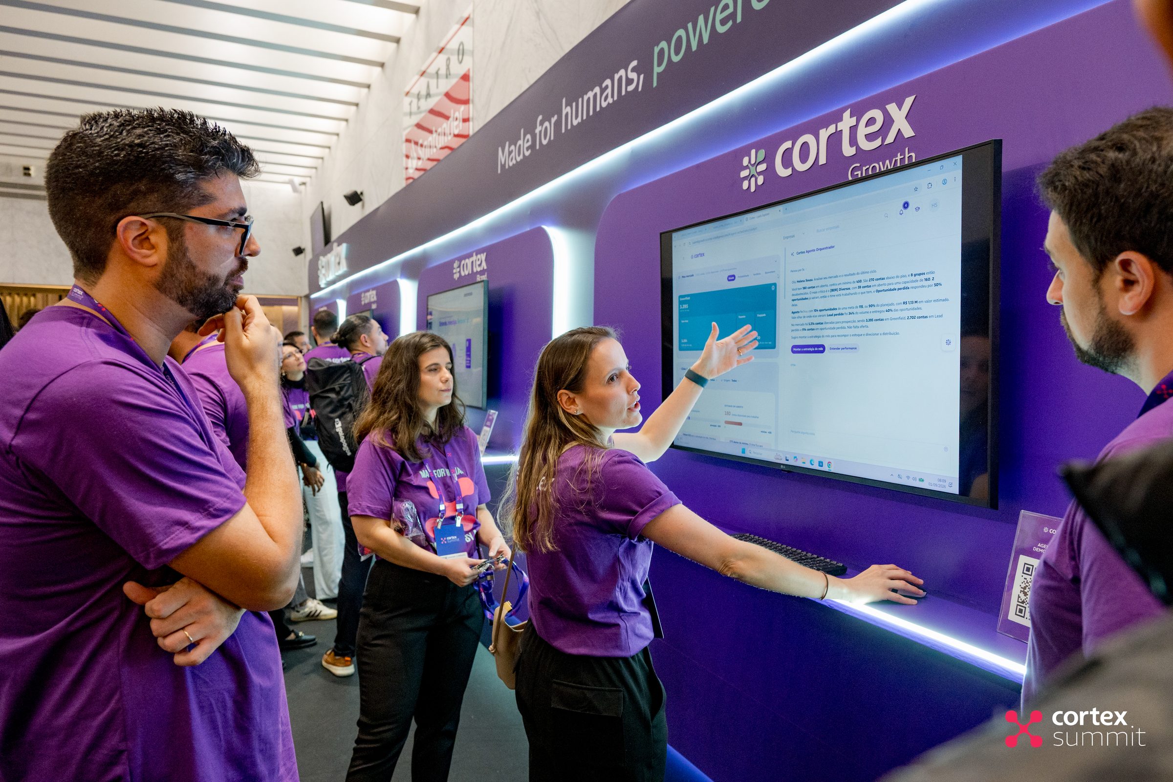Cortex team members showing a product screen to visitors at the stand
