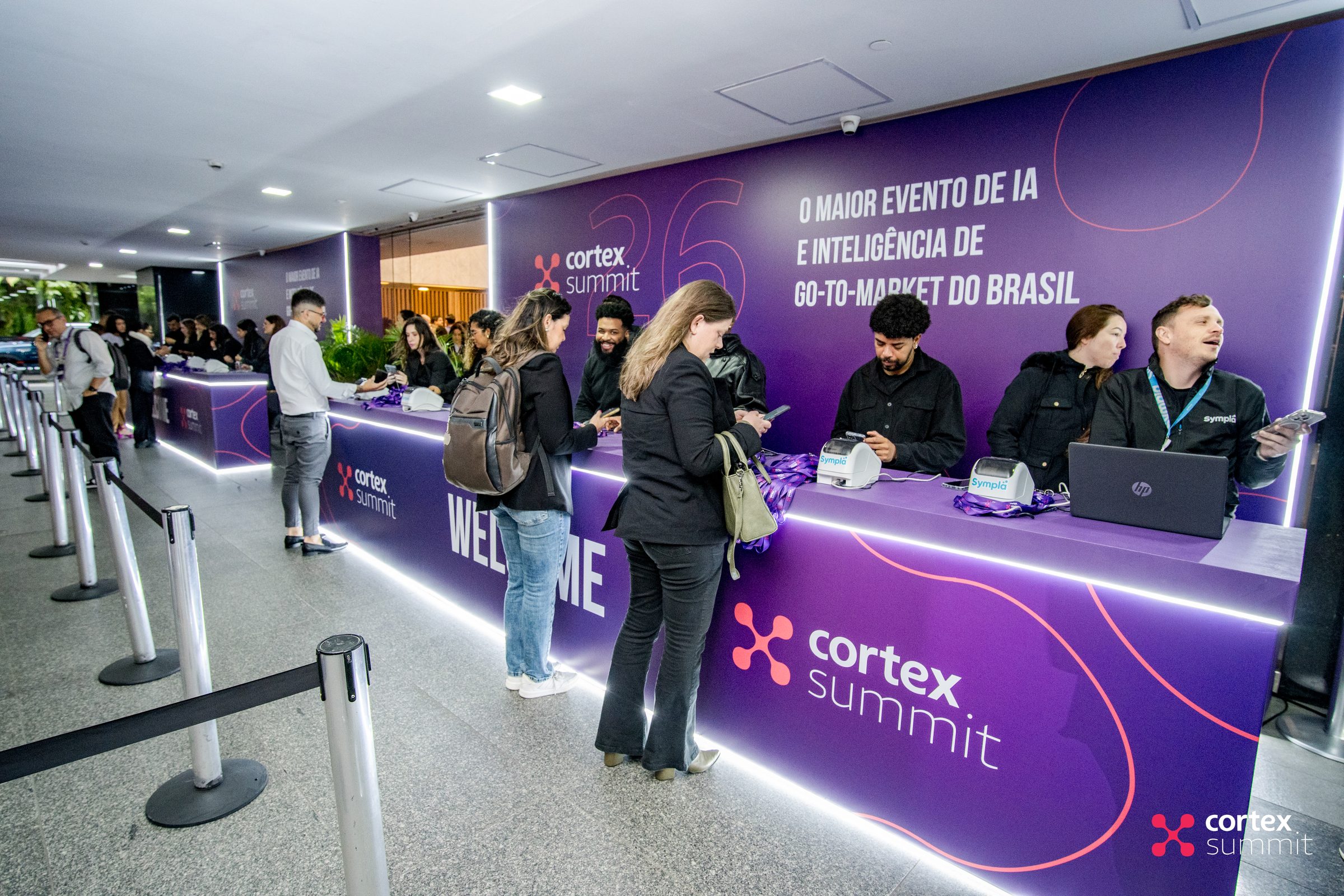 Attendees checking in at the purple Cortex Summit registration desk